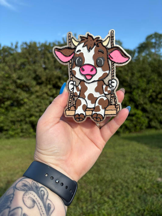 Cow on a swing